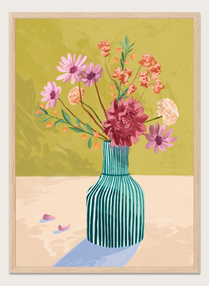 Vase with flowers on a table against a green background. Wildflowers by Goed Blauw is a colorful floral art print and wall poster featuring a striped vase with loose flowers on a warm yellow background.