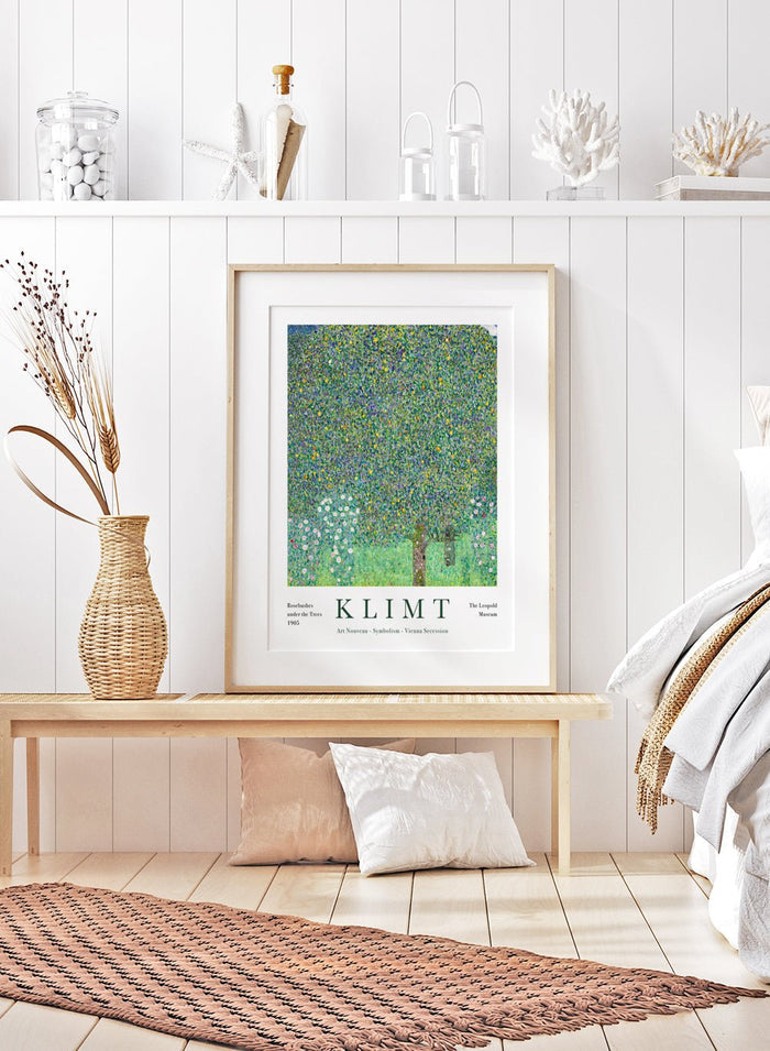 Rosebushes Under the Trees art print by Gustav Klimt is one of those paintings that feels like a memory. Klimt created it while spending summers by Lake Attersee, where he let go of heavy symbolism and focused on the beauty of everyday nature. The leaves turn into a mosaic of greens and yellows, almost buzzing with life, while the small rosebushes ground everything with a soft, gentle sweetness.