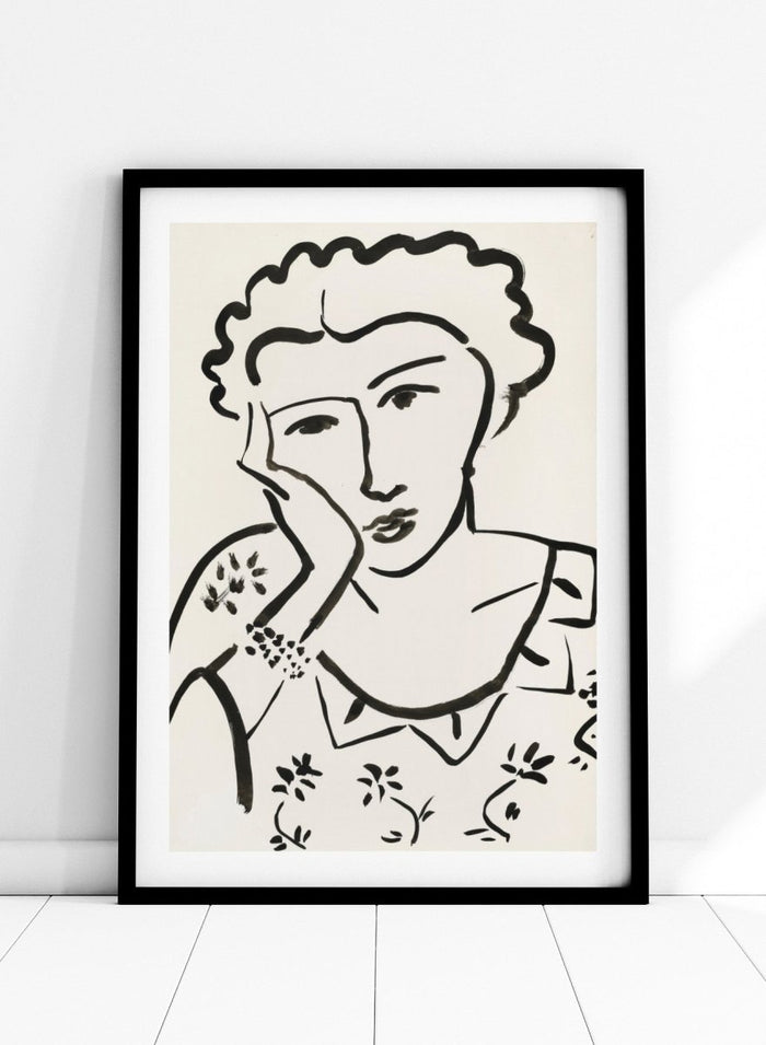 Black line art of a woman with floral patterns on a white background. Jeune Fille Accoudée by Henri Matisse is a minimalist portrait art print featuring expressive black linework, floral detailing, and refined French modernist design.