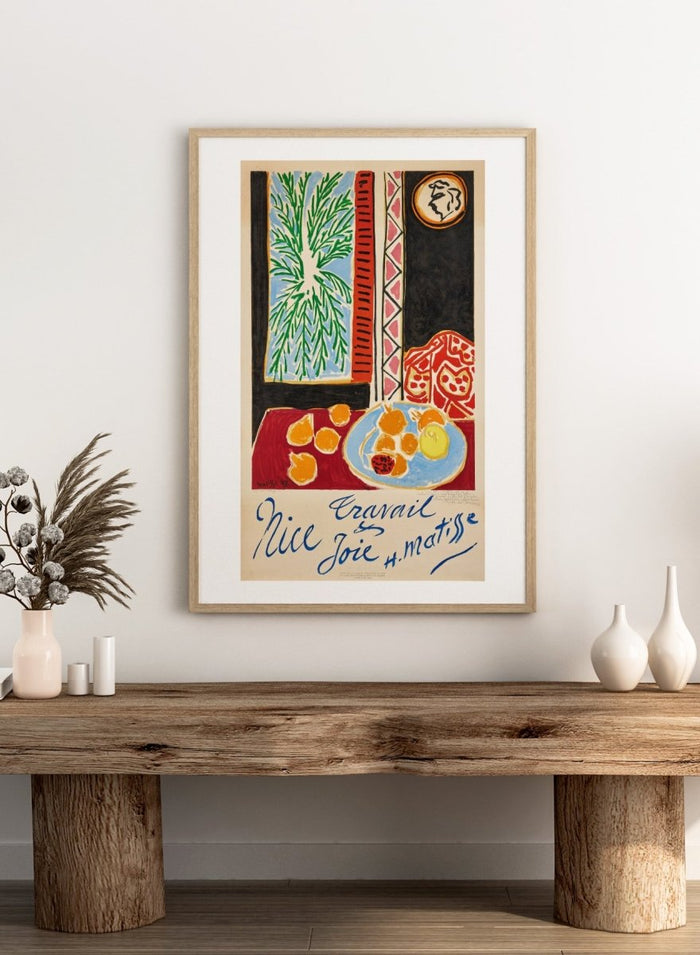 Colorful artwork with a table setting, oranges, and abstract elements on a beige background. Nice, Travail et Joie by Henri Matisse is a colorful 1947 art print featuring Mediterranean interiors, expressive linework, fruit still life details, and modern French design.