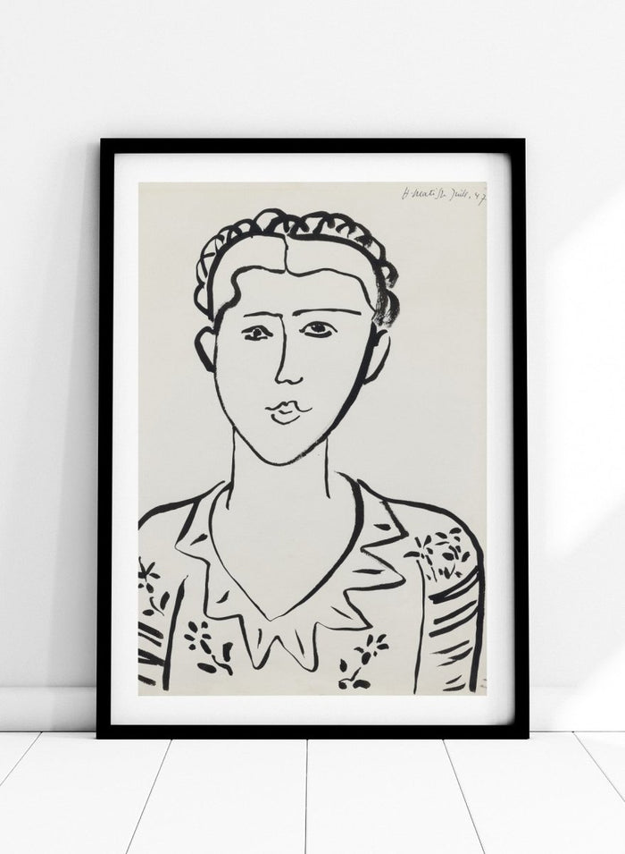 Black line drawing of a woman's portrait on a white background. Portrait de femme by Henri Matisse is a minimalist portrait art print featuring expressive black linework, modern French design, and iconic mid century style.