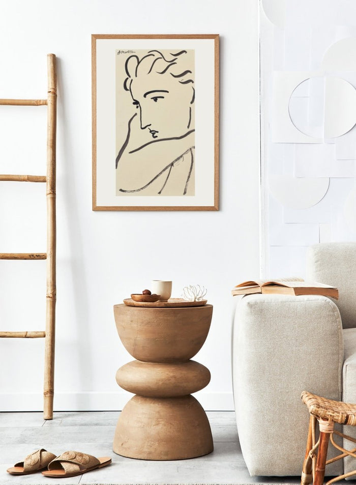 Artistic line drawing of a profiled face on beige paper. Profil de femme by Henri Matisse is a minimalist portrait art print featuring expressive black linework, modern French design, and elegant abstract simplicity.