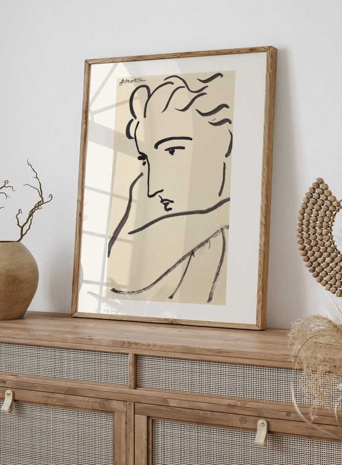 Artistic line drawing of a profiled face on beige paper. Profil de femme by Henri Matisse is a minimalist portrait art print featuring expressive black linework, modern French design, and elegant abstract simplicity.