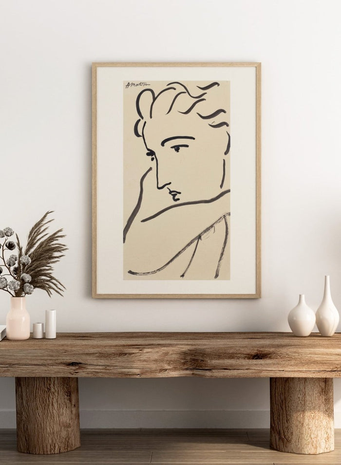 Artistic line drawing of a profiled face on beige paper. Profil de femme by Henri Matisse is a minimalist portrait art print featuring expressive black linework, modern French design, and elegant abstract simplicity.