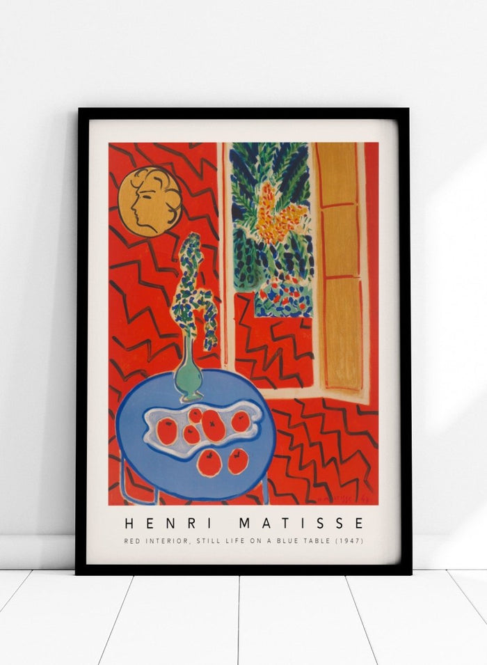 Artistic depiction of a still life scene with a blue table, vase, and fruit, by Henri Matisse. Red Interior, Still Life on a Blue Table by Henri Matisse is a 1947 modern art print featuring bold color, expressive interiors, floral still life details, and iconic French design.