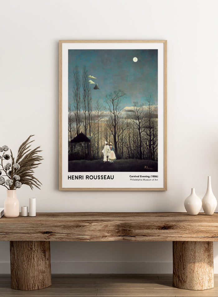 A framed art print of Henri Rousseau's 'Carnival Evening (1886)' painting, featuring a couple in a moonlit forest under a full moon. Carnival Evening by Henri Rousseau is a vintage landscape and portrait art print featuring a moonlit winter forest, costumed couple, bare trees, and deep blue sky.