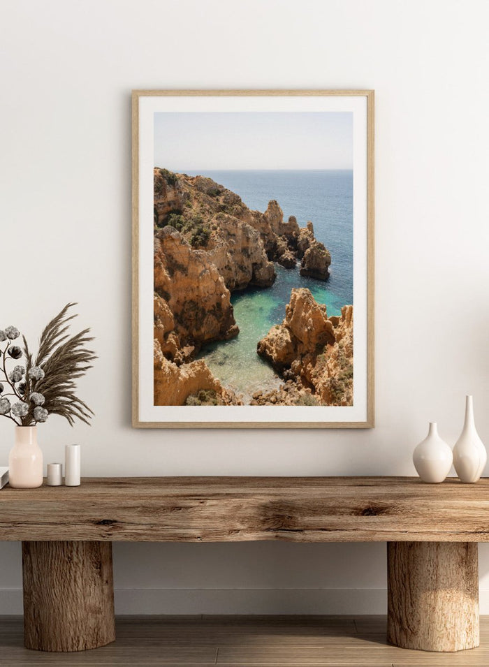 Rocky coastline with clear blue water. Golden Cliffs Azure Ocean by Henrike Schenk is a coastal photography print of rocky sea cliffs overlooking turquoise water and the Mediterranean coastline.