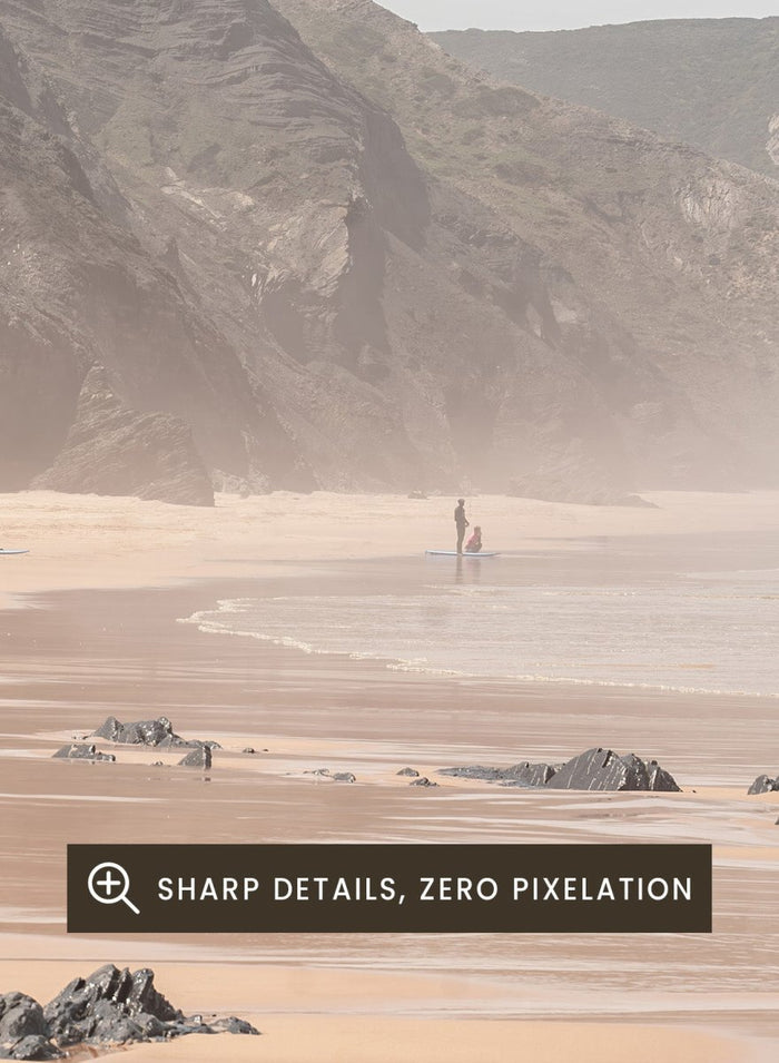Beach scene with mountains in the background. Misty Coastal Landscape by Henrike Schenk is a coastal photography print featuring misty cliffs, sandy beaches, and a peaceful seaside landscape.