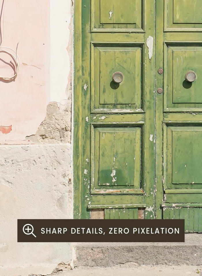 Green door on a pink wall with peeling paint. Old World Green Door by Henrike Schenk features a vintage European doorway, weathered architecture, pastel walls, travel photography, and wall art.