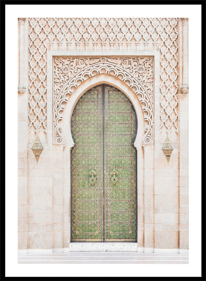 Decorative archway with ornate green door on a light stone wall. Ornate Moroccan Green Door by Henrike Schenk is a Moroccan architecture print featuring an ornate green door, Islamic patterns, and historic stone details.