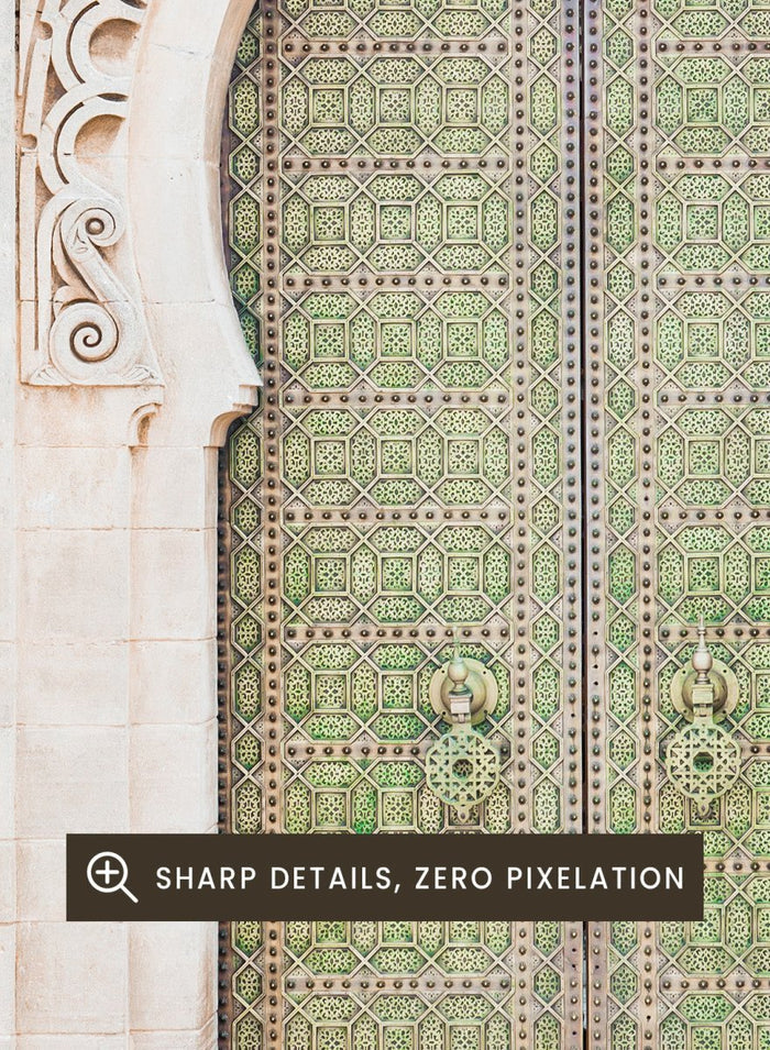 Decorative archway with ornate green door on a light stone wall. Ornate Moroccan Green Door by Henrike Schenk is a Moroccan architecture print featuring an ornate green door, Islamic patterns, and historic stone details.