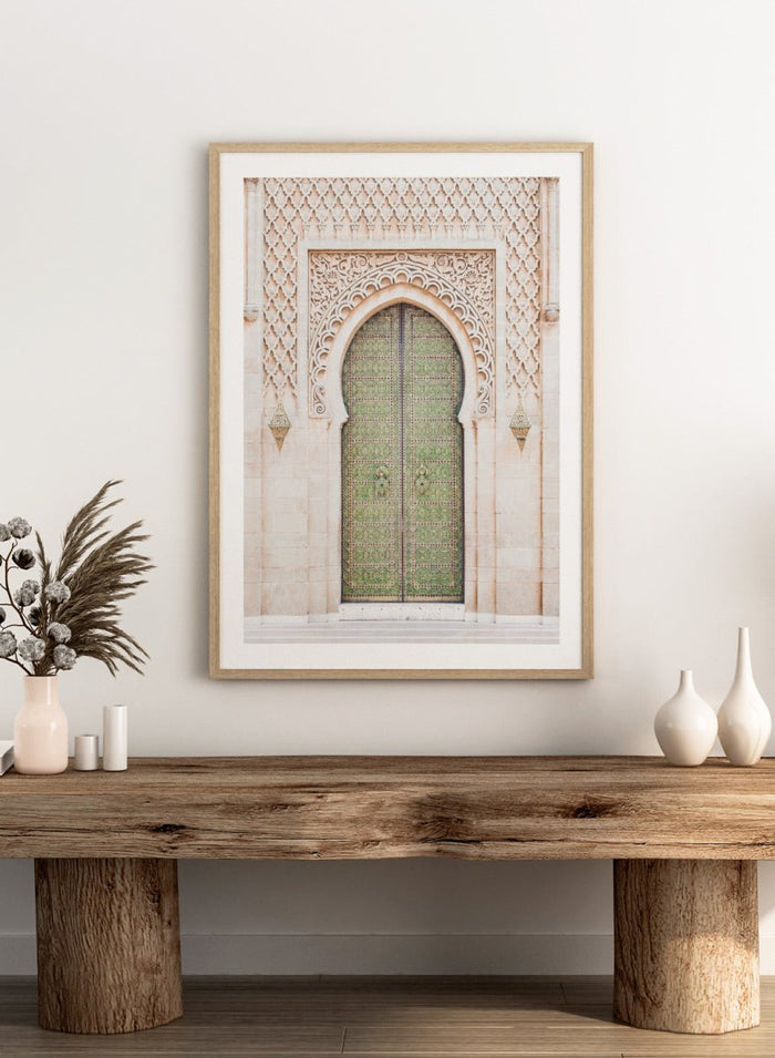 Decorative archway with ornate green door on a light stone wall. Ornate Moroccan Green Door by Henrike Schenk is a Moroccan architecture print featuring an ornate green door, Islamic patterns, and historic stone details.