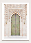 Decorative archway with ornate green door on a light stone wall. Ornate Moroccan Green Door by Henrike Schenk is a Moroccan architecture print featuring an ornate green door, Islamic patterns, and historic stone details.