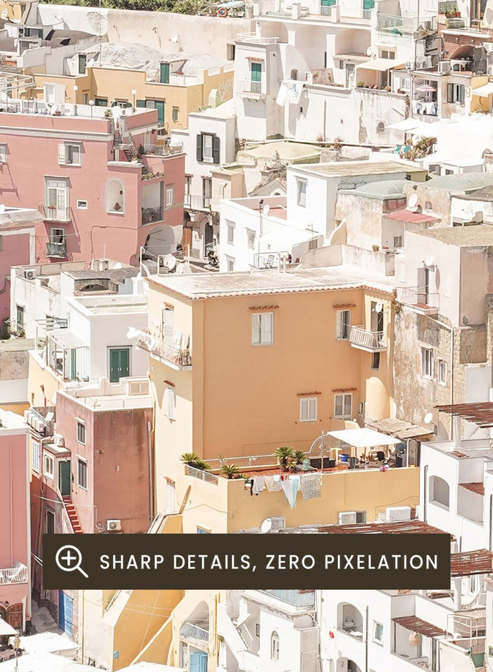 Coastal town with colorful buildings and boats in a harbor. Vibrant Italian Coastal Town by Henrike Schenk is a coastal photography print featuring pastel architecture, turquoise waters, fishing boats, and Mediterranean charm.