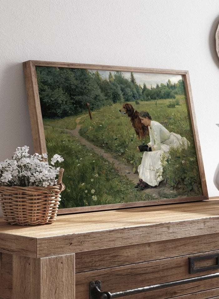 Idyll by Gerhard Munthe is a vintage Norwegian landscape print featuring a woman in a white dress resting with her dog in a green summer meadow.