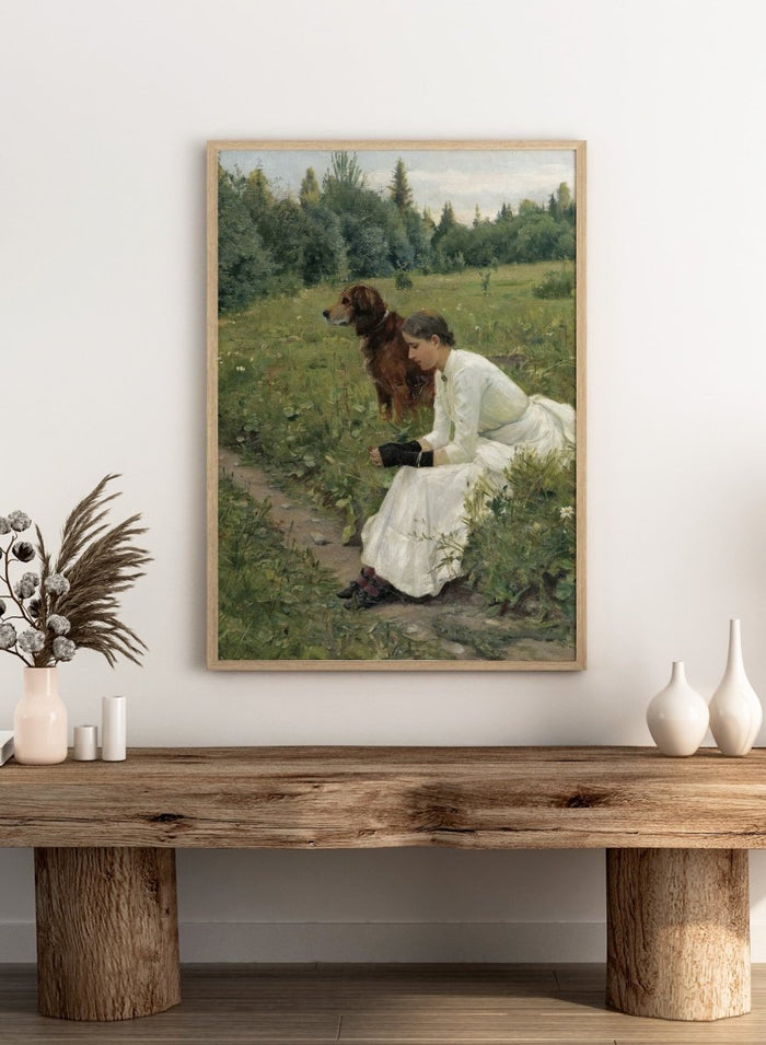 Idyll by Gerhard Munthe is a vintage Norwegian landscape print featuring a woman in a white dress resting with her dog in a green summer meadow.