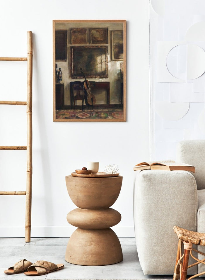 Painting of a room interior with a guitar, chair, and framed pictures. Interior with a Cello by Carl Holsøe is a vintage Danish interior art print featuring a cello, Scandinavian interiors, muted tones, and classic European home decor.