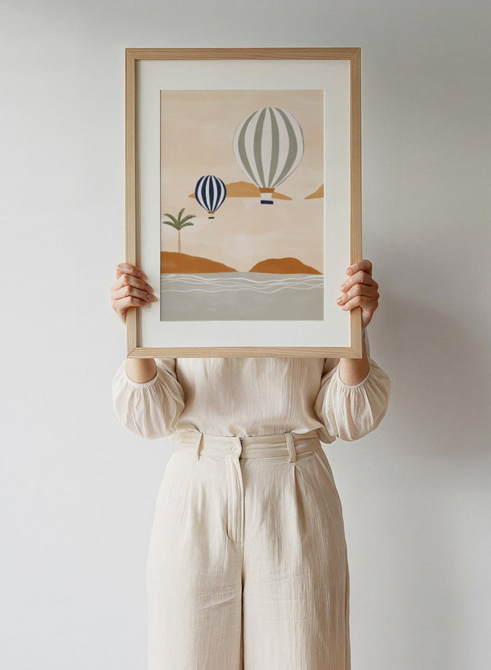 Air Balloons in Desert by Ivy Green is a modern landscape art print featuring hot air balloons over a calm desert scene. Premium fine art print with optional wood framing.
