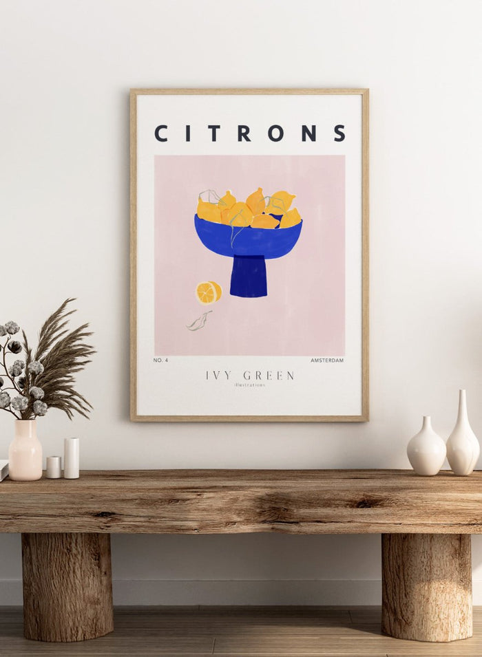 Illustration of lemons in a blue bowl on a pink background with 'Citrons' text and 'Ivy Green' branding. Citrons by Ivy Green lemon art print featuring bowl of lemons illustration, modern fruit poster design, and colorful contemporary kitchen wall art.