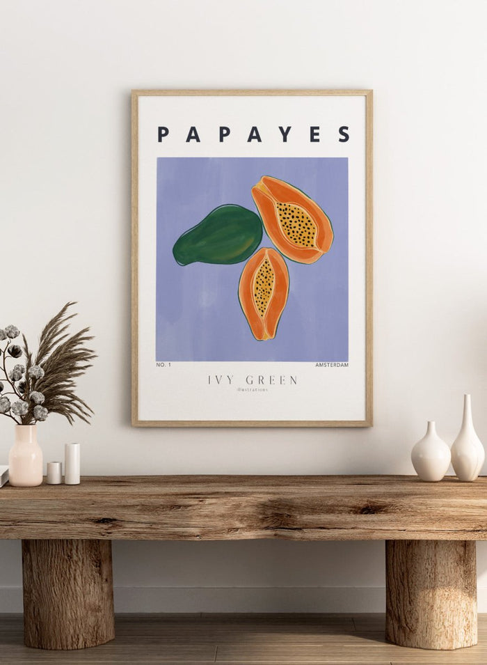 Illustration of papayas and a leaf on a blue background with 'Papayes' text at the top. Papayes by Ivy Green fruit art print featuring papaya illustration, modern food poster design, and colorful contemporary kitchen wall art.