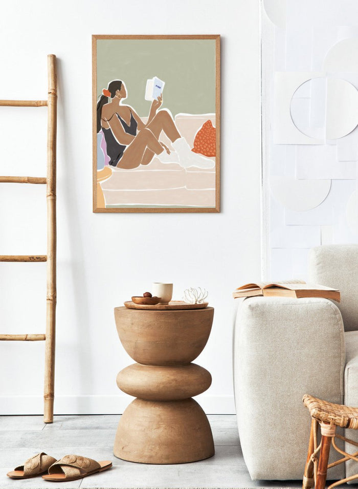 Woman Enjoying a Great Hygge Book by Ivy Green is a cozy modern figure art print celebrating slow living and self-care. Premium fine art print with optional wood framing.