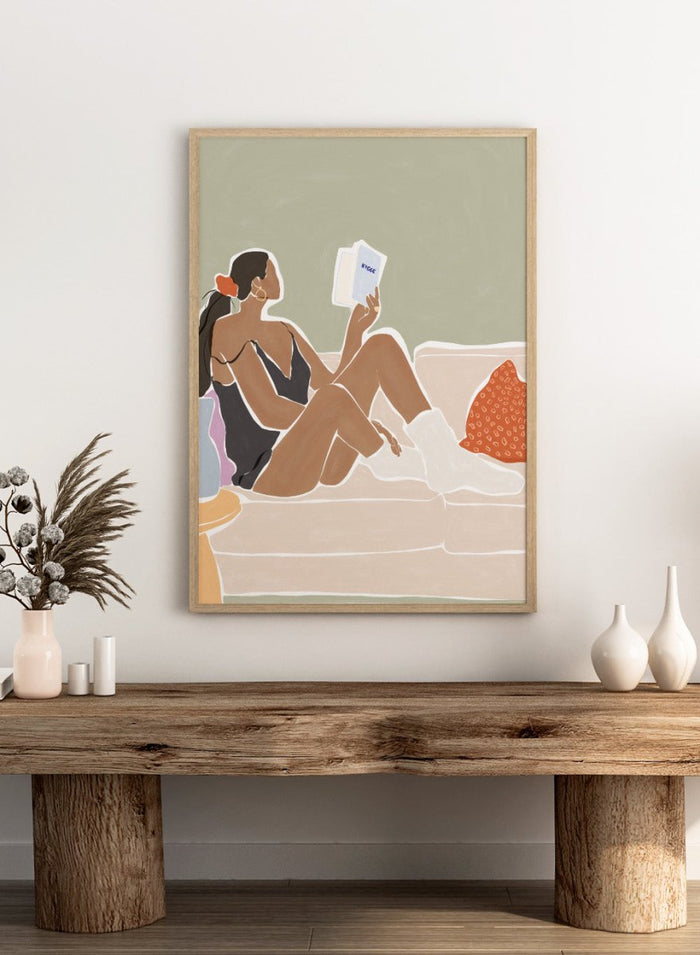 Woman Enjoying a Great Hygge Book by Ivy Green is a cozy modern figure art print celebrating slow living and self-care. Premium fine art print with optional wood framing.