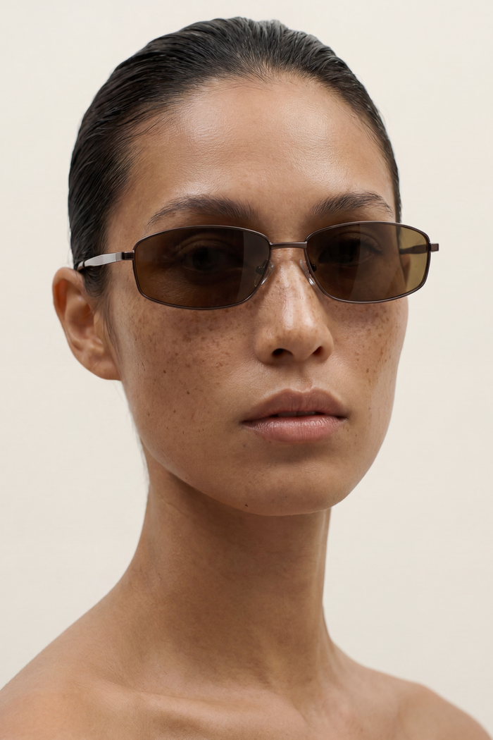 Person wearing sunglasses with a plain background