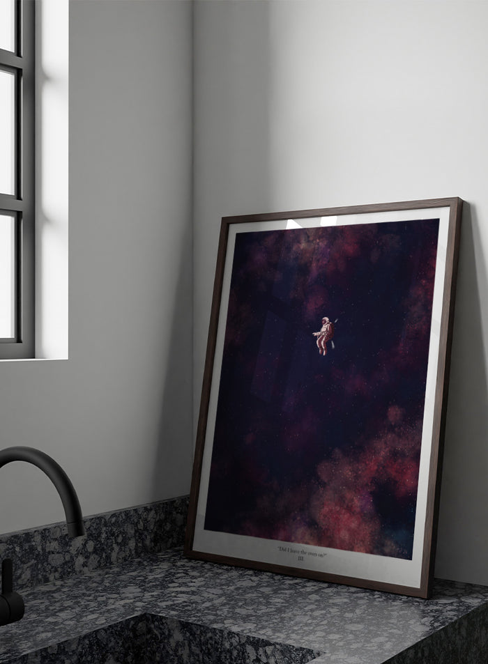 A framed art print featuring an astronaut floating in a starry outer space scene with deep purple, pink, and blue nebulae. The print has a white border with the text 'Did I leave the oven on?' Shop Astronaut In Deep Space by Jake Waldron, a minimalist space wall art print featuring a lone astronaut, starry ga