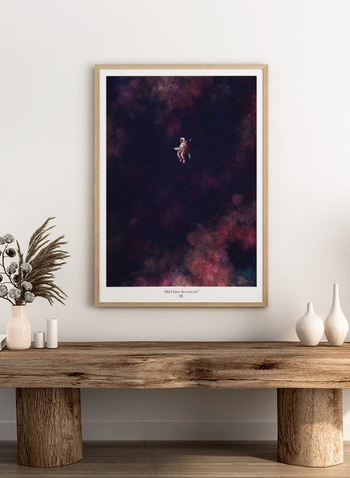 A framed art print featuring an astronaut floating in a starry outer space scene with deep purple, pink, and blue nebulae. The print has a white border with the text 'Did I leave the oven on?' Shop Astronaut In Deep Space by Jake Waldron, a minimalist space wall art print featuring a lone astronaut, starry ga