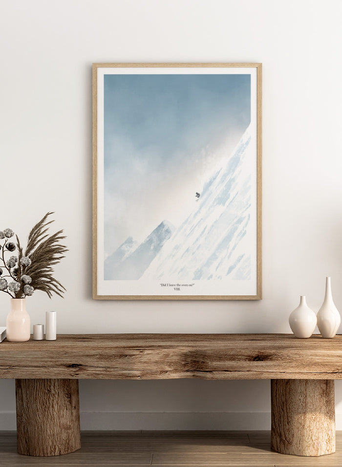 A framed art print featuring a minimalist illustration of a skier on a snowy mountain slope under a pale blue sky, with the text 'Did I leave the oven on?' at the bottom. Shop Extreme Mountain Skiing by Jake Waldron, a minimalist ski wall art print featuring alpine mountains, extreme skiing, and soft blue winter tones.
