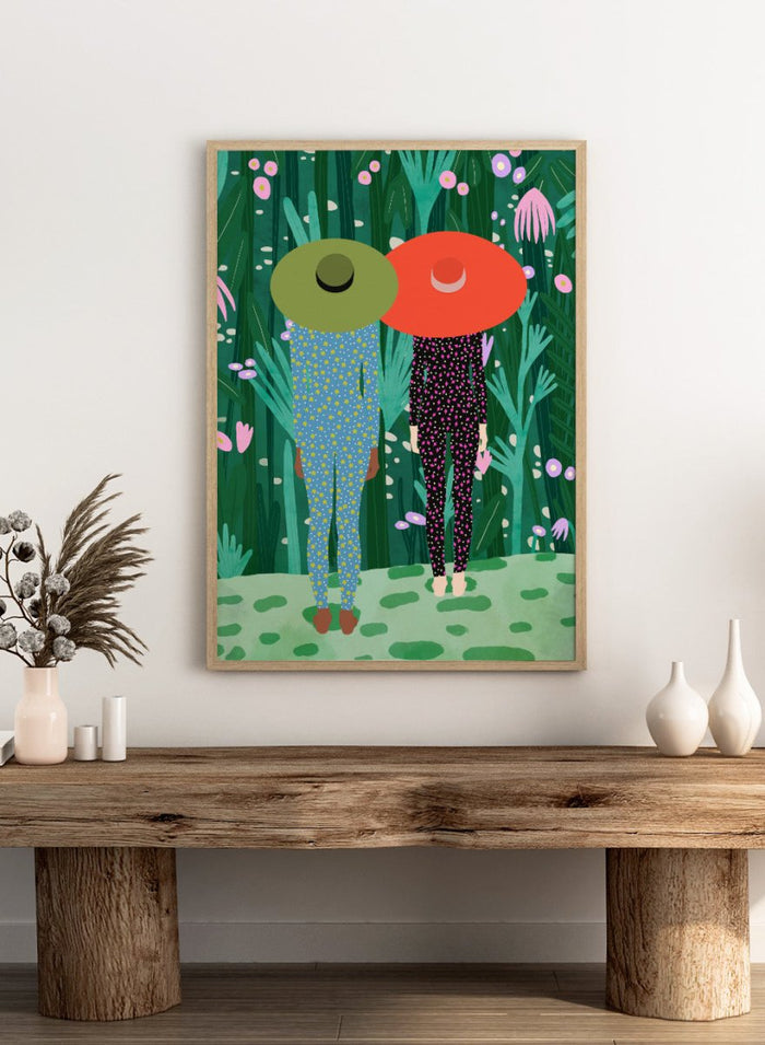 Two people with large hats walking through a lush, colorful forest. Jungle Pajamas by Jota de Jai is an officially licensed fine art wall poster about friendship and quiet connection, available framed or unframed.