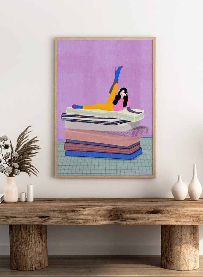 Illustration of a person sitting on a stack of books with one arm raised against a purple background. Mattress Ballet by Jota De Jai is a playful modern fine art print of a woman balancing on stacked mattresses. Available unframed or framed in real wood.