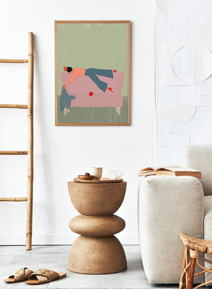 Illustration of a person lying on a pink couch with a red flower, against a green background. Rocío by Jota de Jai is a modern fine art print of a woman draped across a pink sofa with a red rose, officially licensed wall poster available framed in real wood.