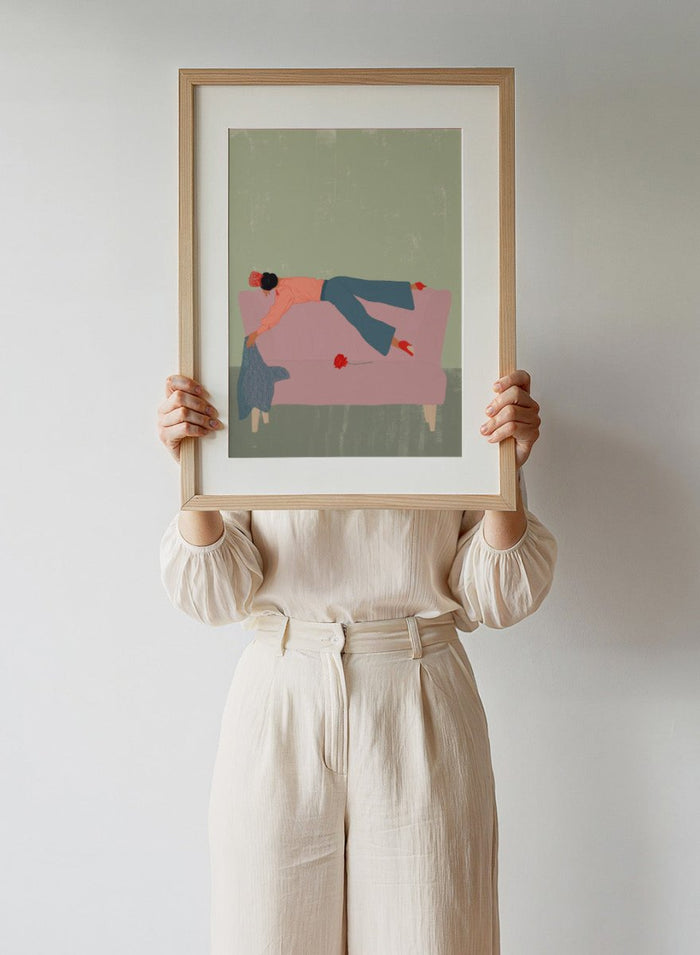 Illustration of a person lying on a pink couch with a red flower, against a green background. Rocío by Jota de Jai is a modern fine art print of a woman draped across a pink sofa with a red rose, officially licensed wall poster available framed in real wood.