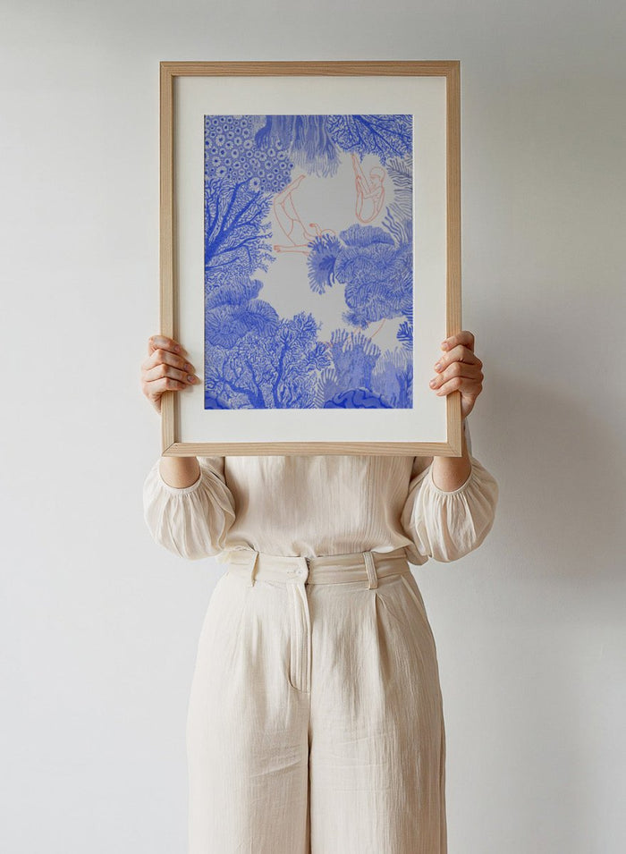Illustration of people climbing on coral with blue and white patterns. Underwater by Jota de Jai is a modern blue wall art print of swimmers drifting through an ocean coral illustration, available as a premium fine art poster with optional wood framing.