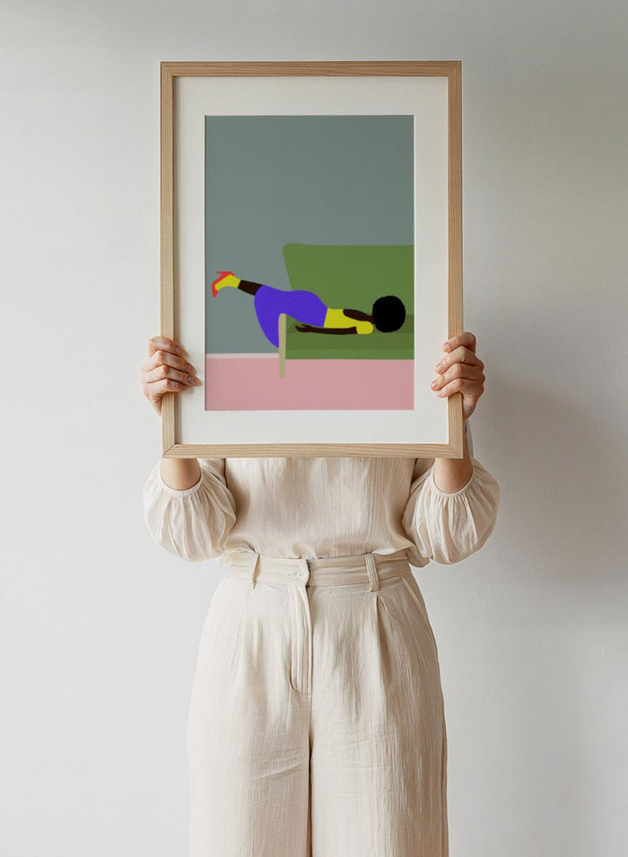 Simplified illustration of a person lying on a green couch with a gray wall and pink floor. Wendy’s Mood by Jota de Jai is a modern art print of a woman lounging dramatically on a green couch, officially licensed wall poster with fine art printing and framing.