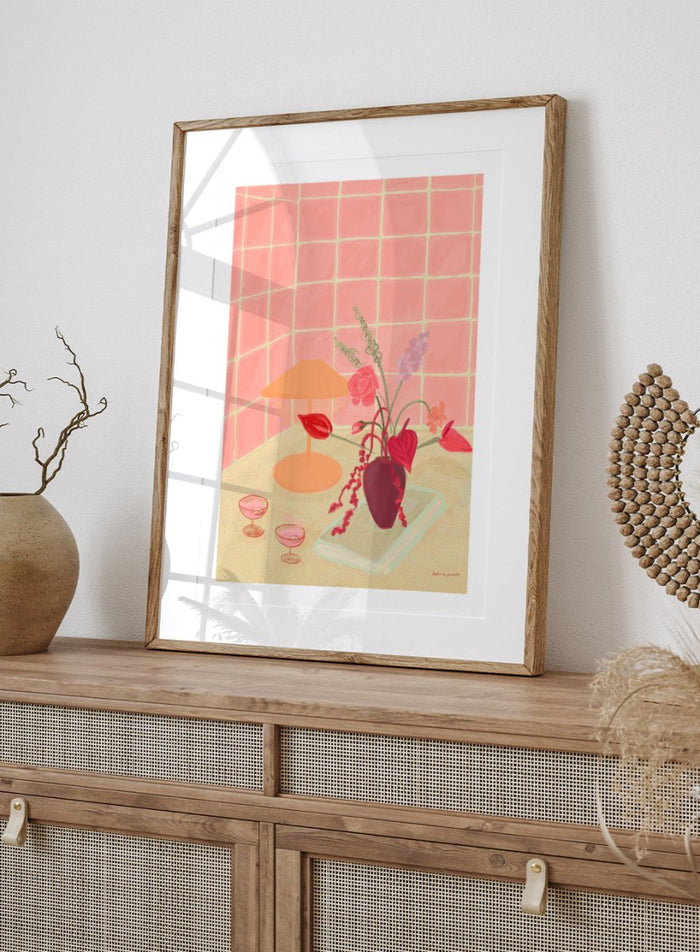 Illustration of a table with a vase of flowers, two glasses, and an orange lamp against a pink tiled wall. Bubbly by Katharina Puritscher art print featuring pink tiled walls, floral still life, coupe glasses, and a cozy tabletop scene. Officially licensed wall poster.