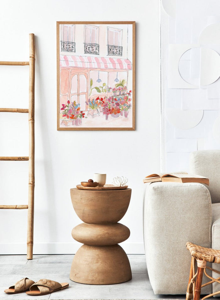 Illustration of a flower shop with a striped awning and flowers in front. Pink Flower Shop by Katharina Puritscher features a Paris-inspired storefront illustration with colorful bouquets, soft watercolor textures, and European street details. Floral art print with optional framing.