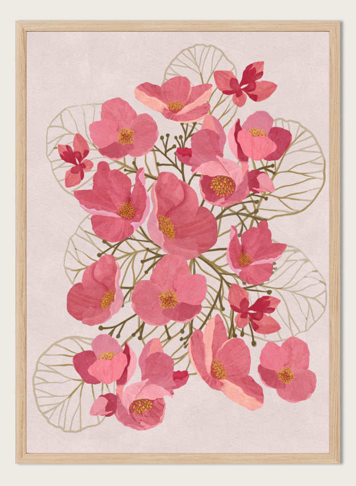 A framed botanical art print featuring pink flowers with yellow centers and delicate gold leaf outlines on a pale pink background. Shop Japanese Quince Floral Art Print by Katie O'Shea, a botanical floral art print featuring pink quince blossoms, soft leaves, and fresh spring color.