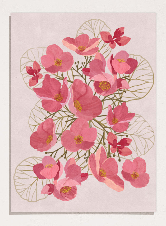 A framed botanical art print featuring pink flowers with yellow centers and delicate gold leaf outlines on a pale pink background. Shop Japanese Quince Floral Art Print by Katie O'Shea, a botanical floral art print featuring pink quince blossoms, soft leaves, and fresh spring color.
