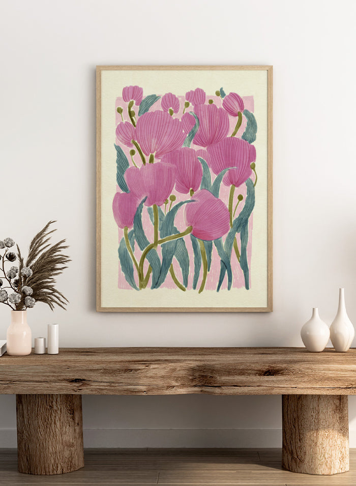 A framed art print featuring a stylized illustration of pink tulips with textured green leaves on a light cream background. Shop Pink Tulips by Katie O'Shea, a botanical floral art print featuring layered pink tulips, blue-green leaves, fine linework, and soft spring color.