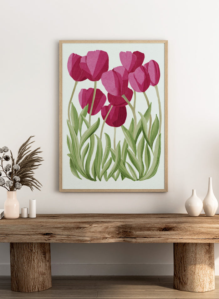 A stylized floral illustration of pink tulips with green leaves on a white background. Shop Tulips Floral Art Print by Katie O'Shea, a botanical floral art print featuring deep pink tulips, tall green leaves, and fresh spring color.