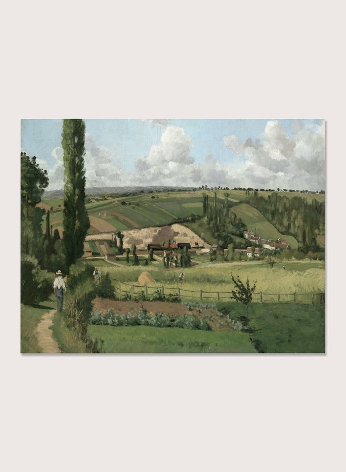 A framed landscape painting depicting a green countryside scene with rolling hills, trees, a path, small buildings, and a cloudy sky. Landscape at Les Pâtis, Pontoise by Camille Pissarro is a vintage French landscape print featuring green fields, farm workers, rolling hills, and a summer sky.