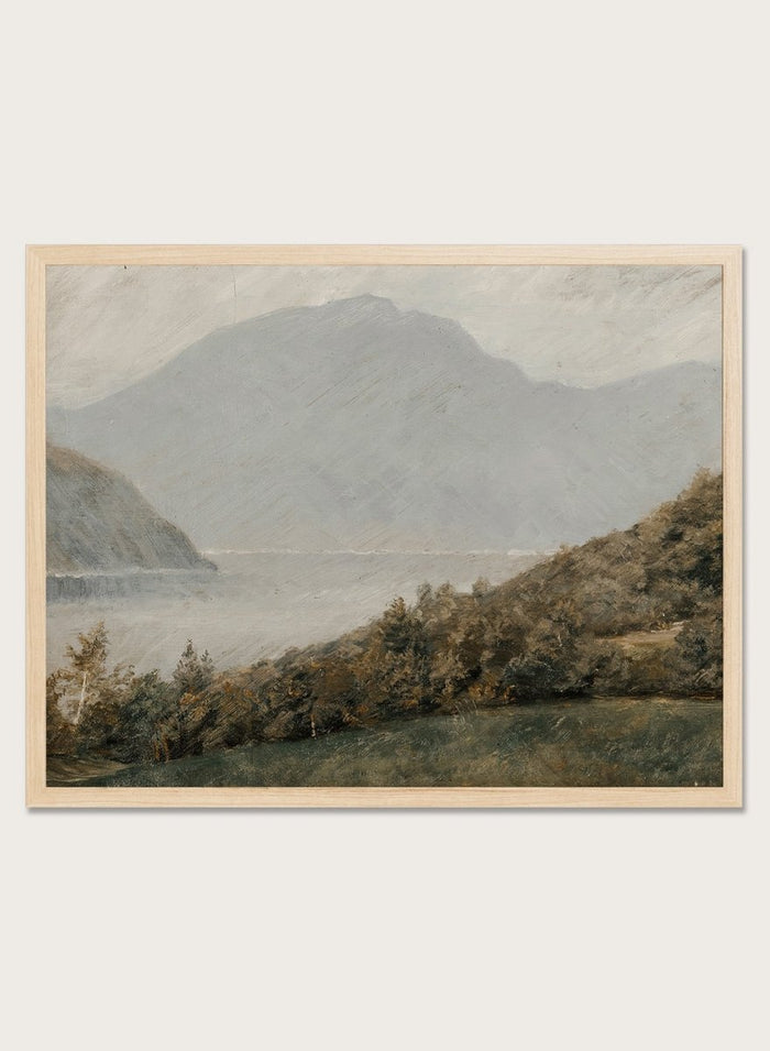 A framed landscape painting depicting a misty mountain range over a body of water with trees in the foreground. Landscape with Mountains in the Background by Susette Holten is a vintage mountain landscape print featuring a lake, misty peaks, trees, and muted natural tones.