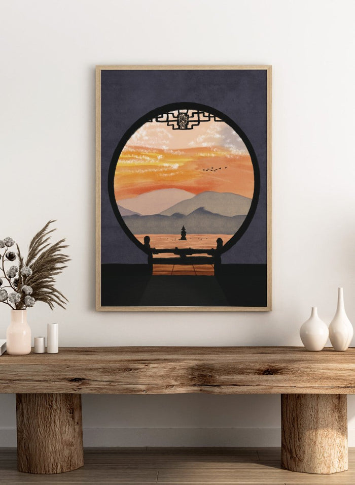A framed art print depicting a scenic landscape viewed through a circular window frame. The scene shows layered mountains under a warm orange and yellow sunset sky with a small pagoda-like structure and birds, set against a dark gray background. Asian Pagoda Sunset View by Lisa Solomoniuk premium framed fine art print featuring layered mountains, a distant pagoda, and a glowing peach sunset.