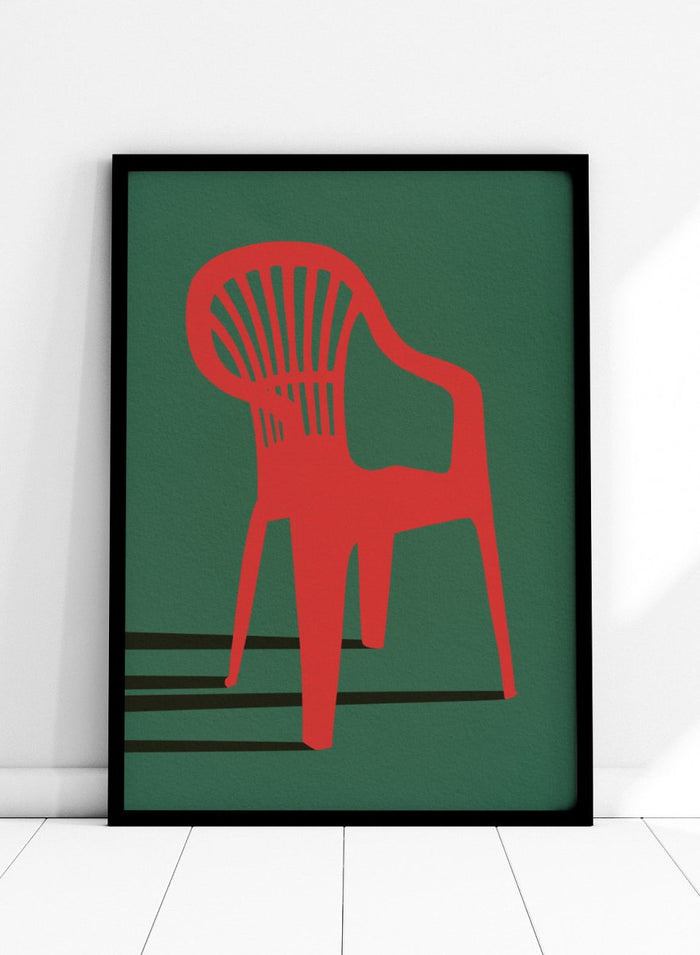 Bold Red Chair by Lisa Solomoniuk premium framed fine art print featuring a vivid red chair, deep green background, and long black shadows.