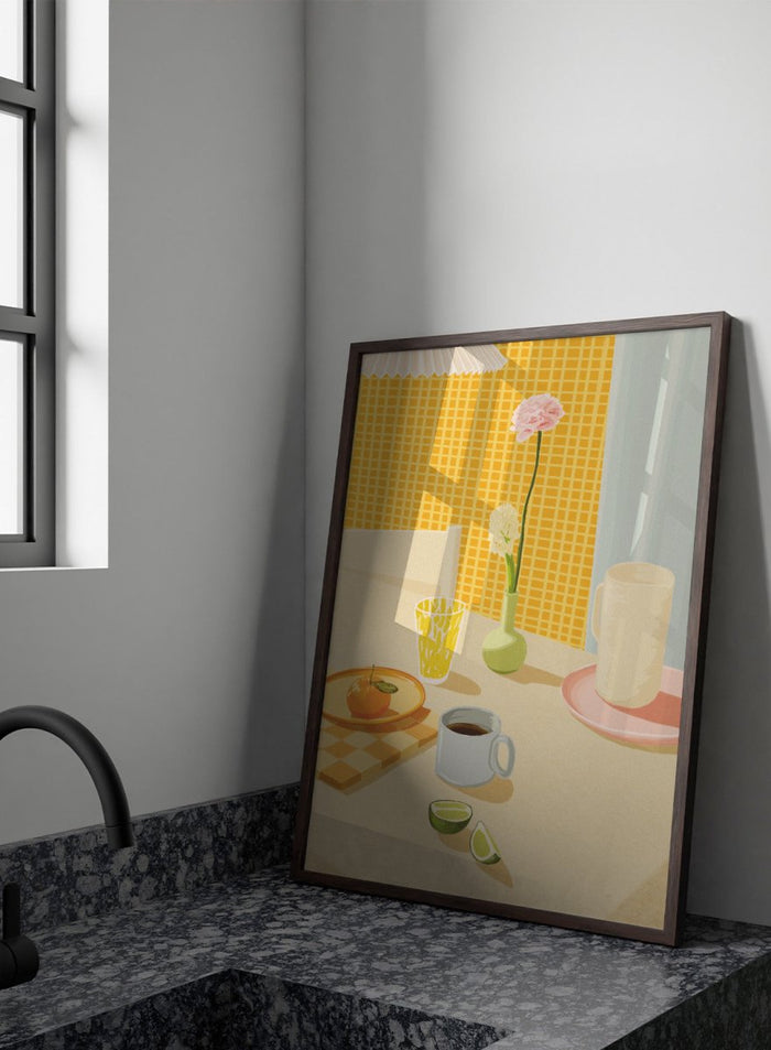 A stylized illustration of a tabletop scene with a pink flower in a small green vase, a yellow patterned glass, a white mug on a pink saucer, a gray mug of coffee, a sliced lime, and an orange on a checkered mat against a yellow tiled wall. Bright Breakfast Table by Lisa Solomoniuk premium framed fine art print featuring morning coffee, citrus fruit, flowers, and colorful tableware.