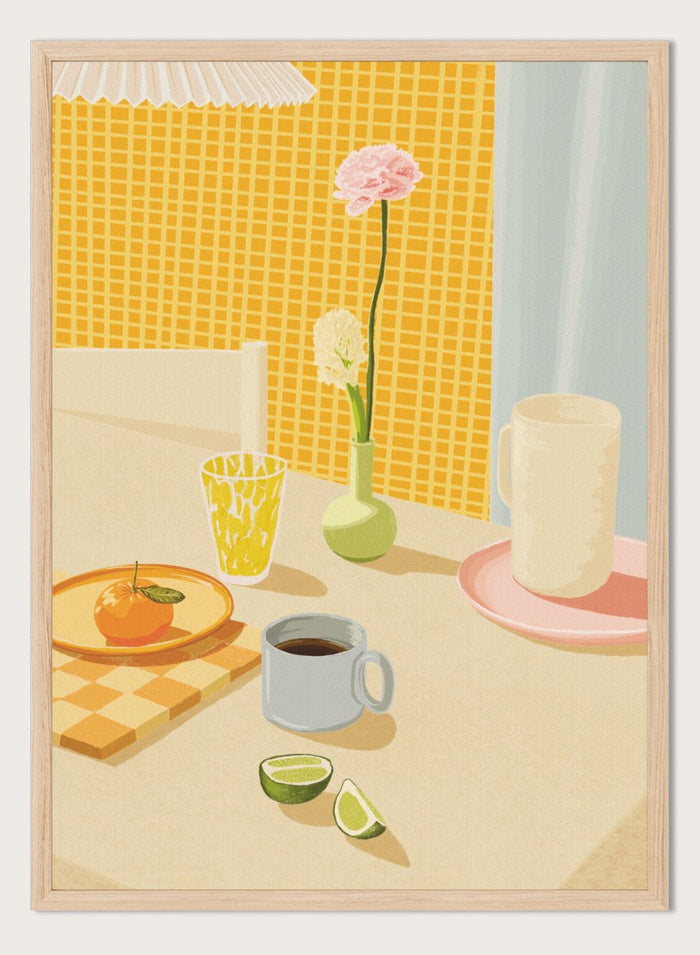 A stylized illustration of a tabletop scene with a pink flower in a small green vase, a yellow patterned glass, a white mug on a pink saucer, a gray mug of coffee, a sliced lime, and an orange on a checkered mat against a yellow tiled wall. Bright Breakfast Table by Lisa Solomoniuk premium framed fine art print featuring morning coffee, citrus fruit, flowers, and colorful tableware.