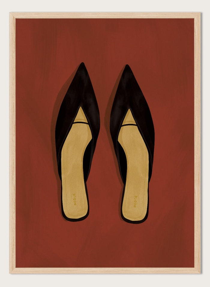 A pair of black pointed-toe flat mules with a contrasting beige insole, displayed flat against a solid reddish-brown background. Chic Black Mules by Lisa Solomoniuk premium framed fine art print featuring pointed black shoes with golden insoles against a rich rust red background.