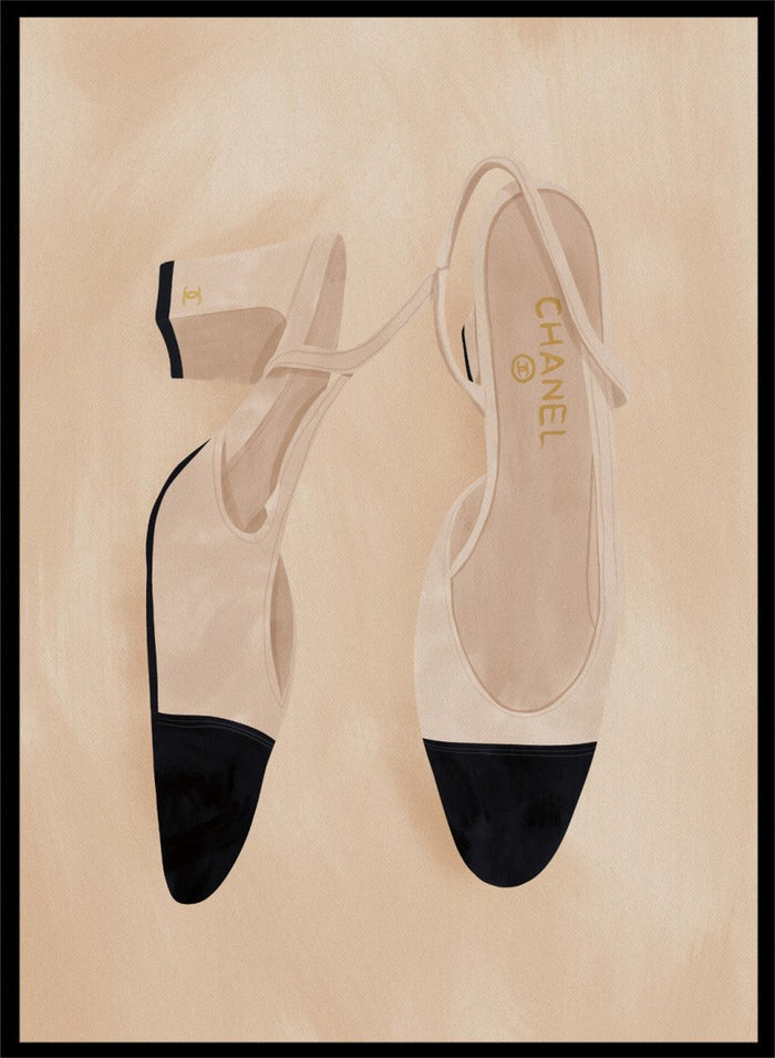 A pair of slingback flats with a beige and black color-blocked design, displayed on a textured beige background with a black border. Chic Cap-Toe Heels by Lisa Solomoniuk premium framed fine art print featuring cream slingback heels with black cap toes on a soft beige background.
